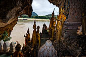 Luang Prabang, Laos - The Pak Ou Caves, the lower cave called Tham Ting. The caves, a Buddhist pilgrimage site, are a repository of old Buddha statues. 